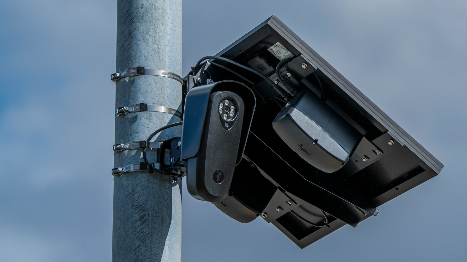 Flock Safety surveillance camera on a traffic pole.